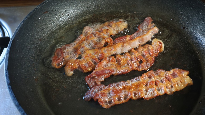 frying bacon in pan