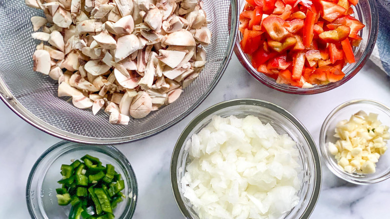 Chopped vegetables in bowls and strainer