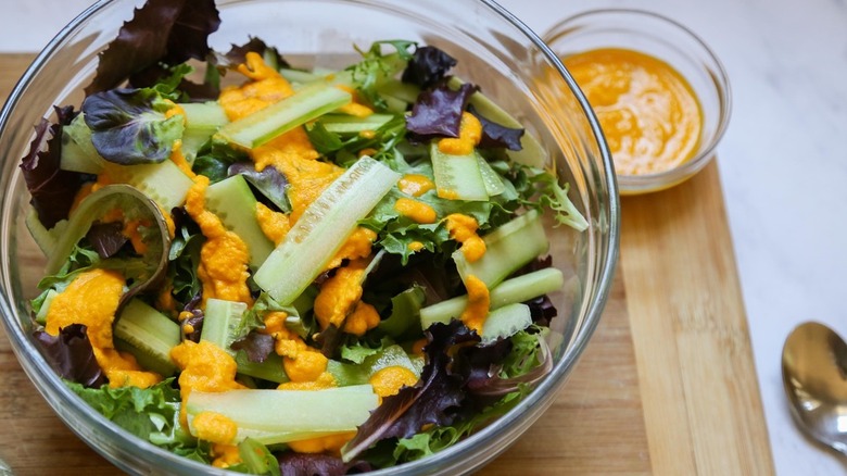 Miso Ginger Salad in a bowl with dressing on top and on the side