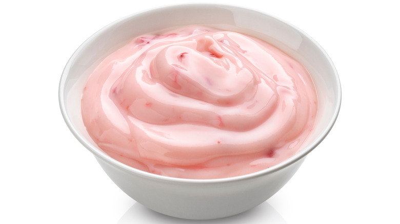 strawberry yogurt, pink berry cream in bowl isolated on white background with clipping path