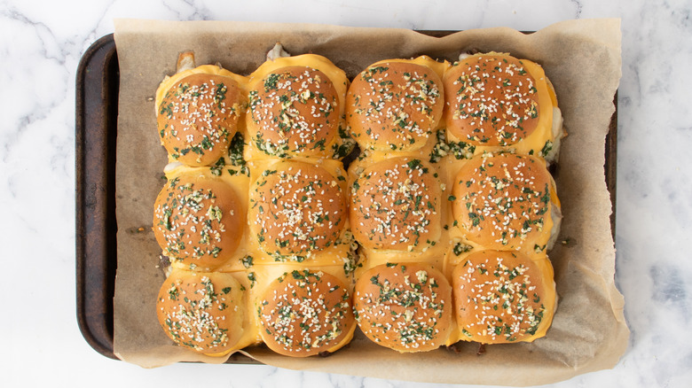 Slider rolls covered with chopped parsley and sesame seeds