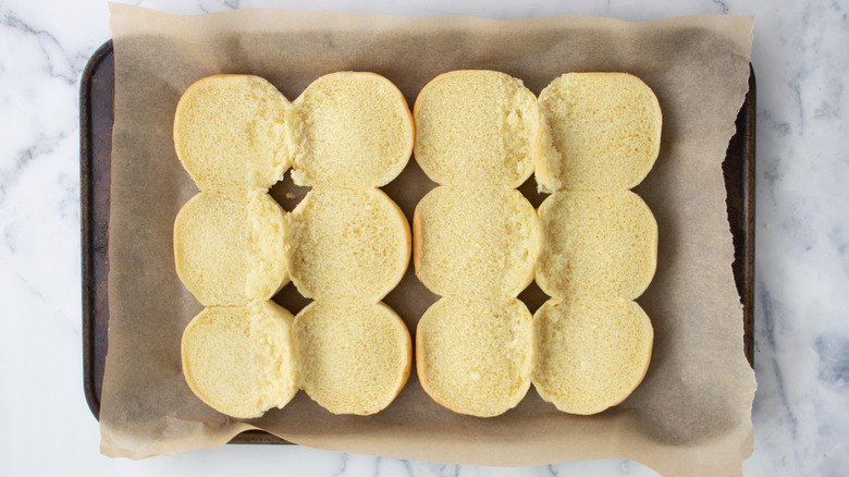 Open slider rolls in a baking pan