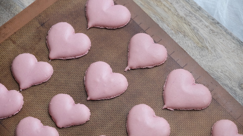 heart-shaped macarons on counter