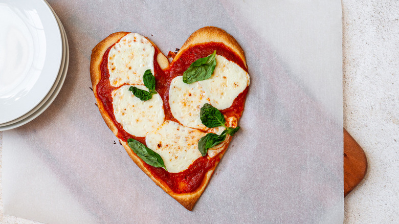 heart-shaped pizza on table