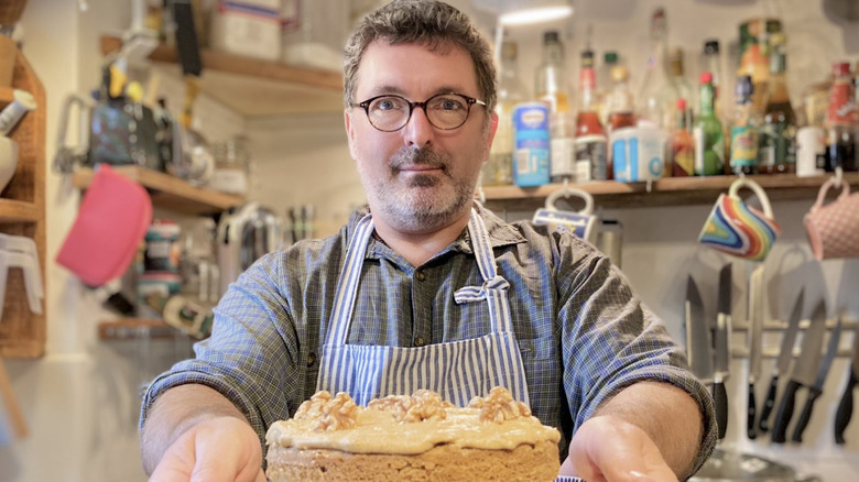 Marc Elliott holding layer cake