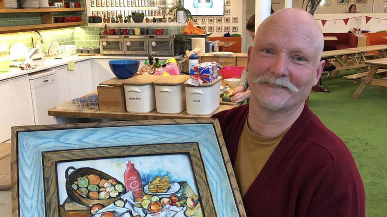 Terry Hartill holding a still life cake