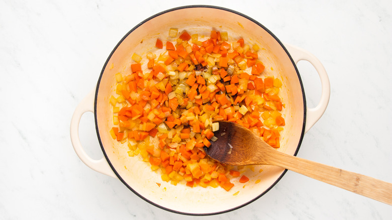 Carrot and onion cooking in casserole pan