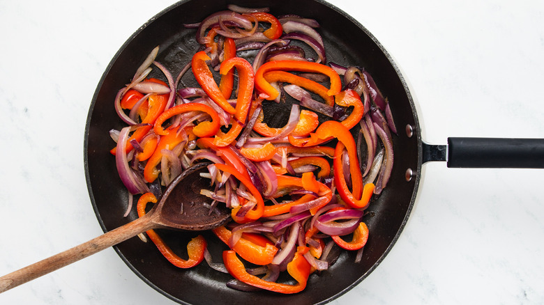 Onion and pepper frying in pan