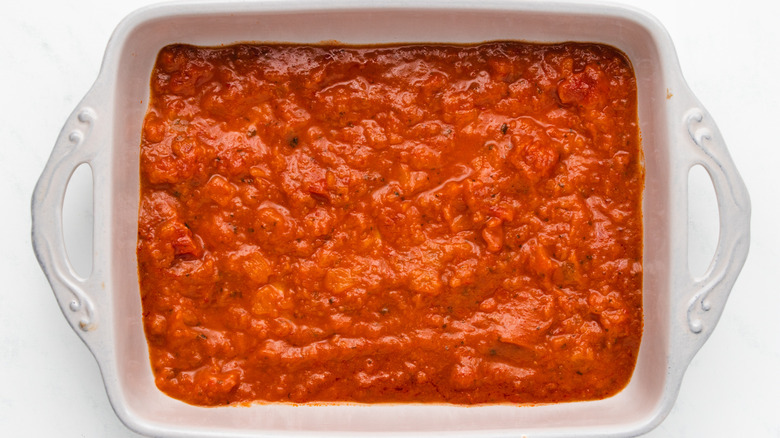 Red enchilada sauce in baking dish