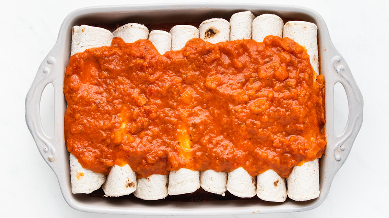 Enchiladas covered in red sauce