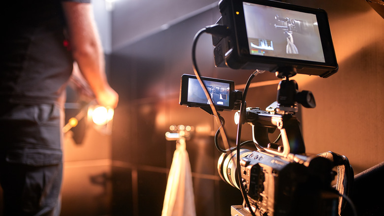 A camera in front of an orange background