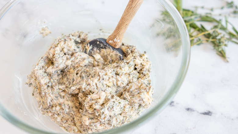 mixing herbed butter in a bowl