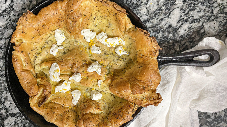 Dutch baby in skillet with goat cheese