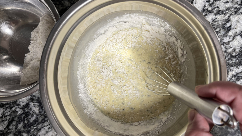 Hand whisking batter in mixing bowl