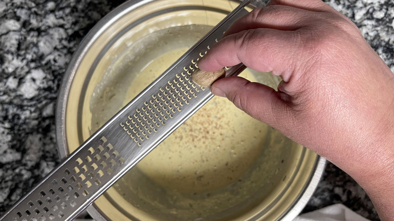 Fresh nutmeg grating into batter