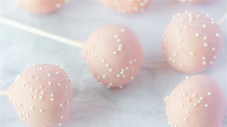 Cake pops with pink coating and white sprinkles