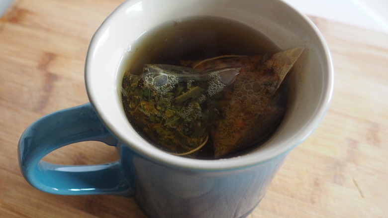 Mug with hot tea and tea bags.