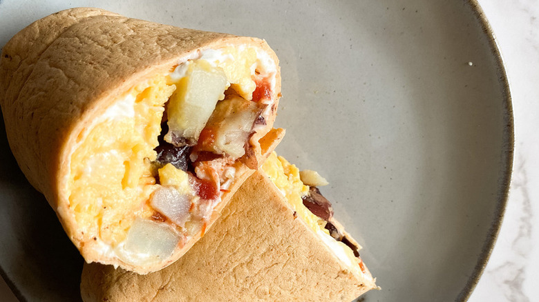 Wrap sandwich with eggs, diced meat, and veggies. 