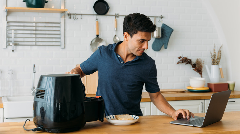 man using air fryer