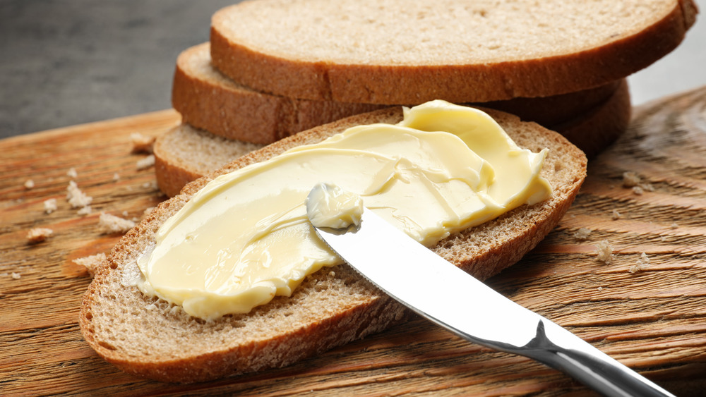 Butter being spread on toast