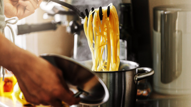 Removing cooked pasta from pot