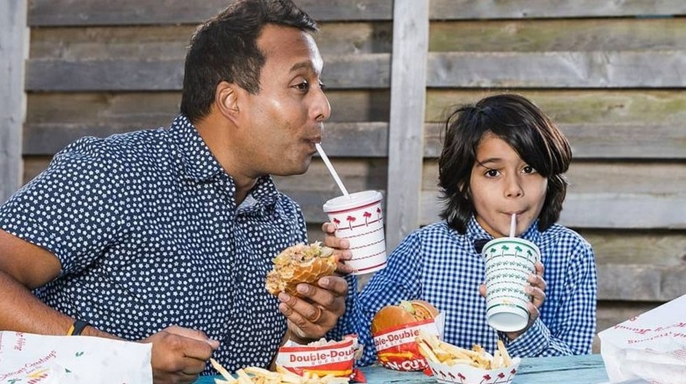 Ali Khan and his son eat hamburgers 