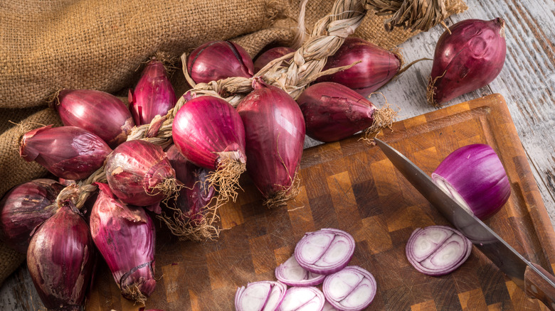 Chopping board with onions and knife