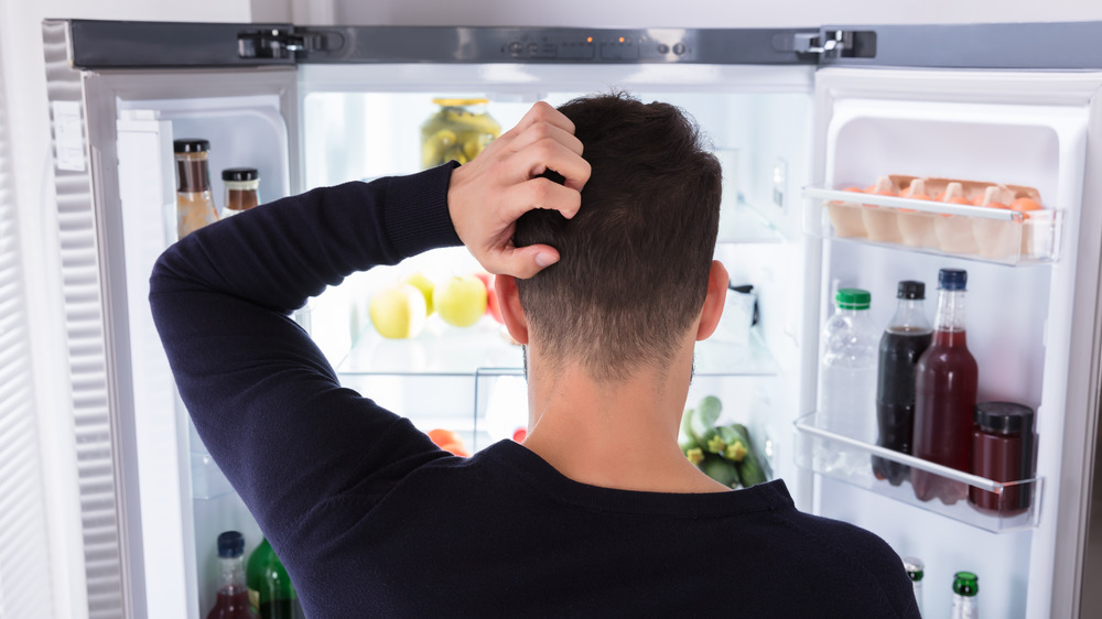 Man looking in fridge