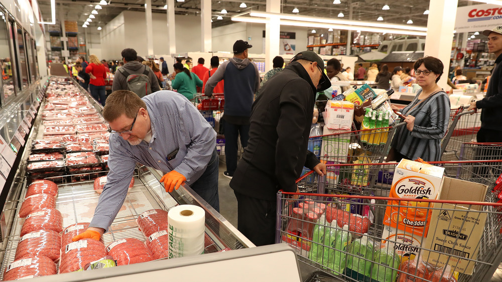 Customers shopping inside busy Costco warehouse