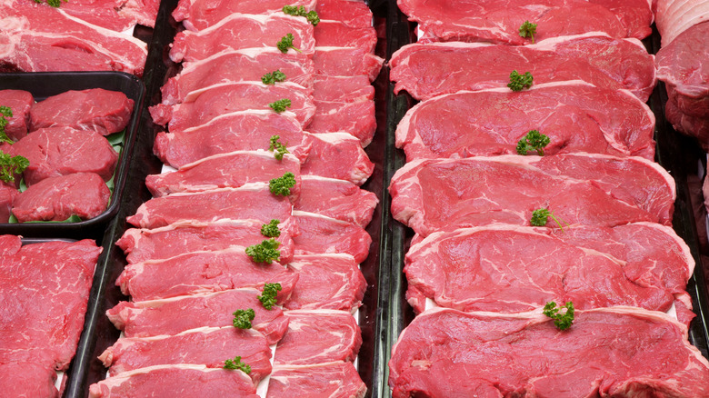 trays with cuts of raw steak