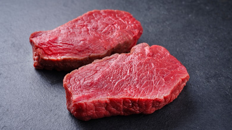 two cuts of raw steak