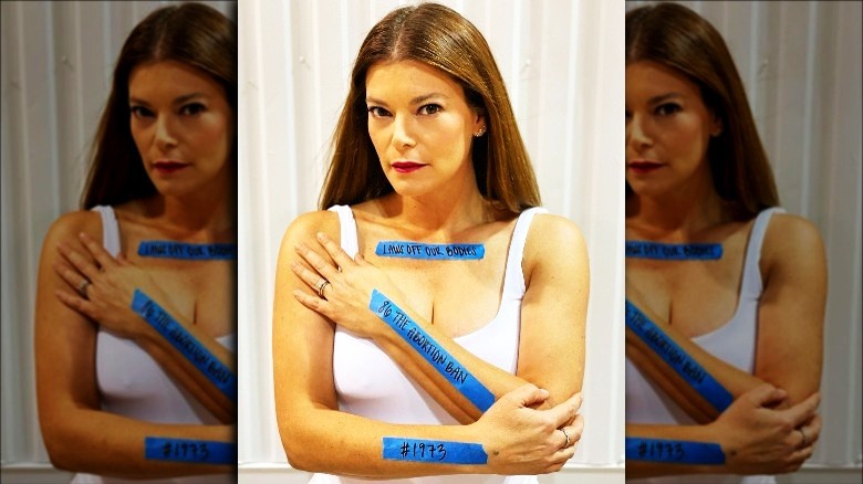 Gail Simmons with protest messages taped to body