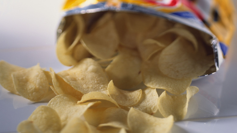 Potato chips tumbling out of bag