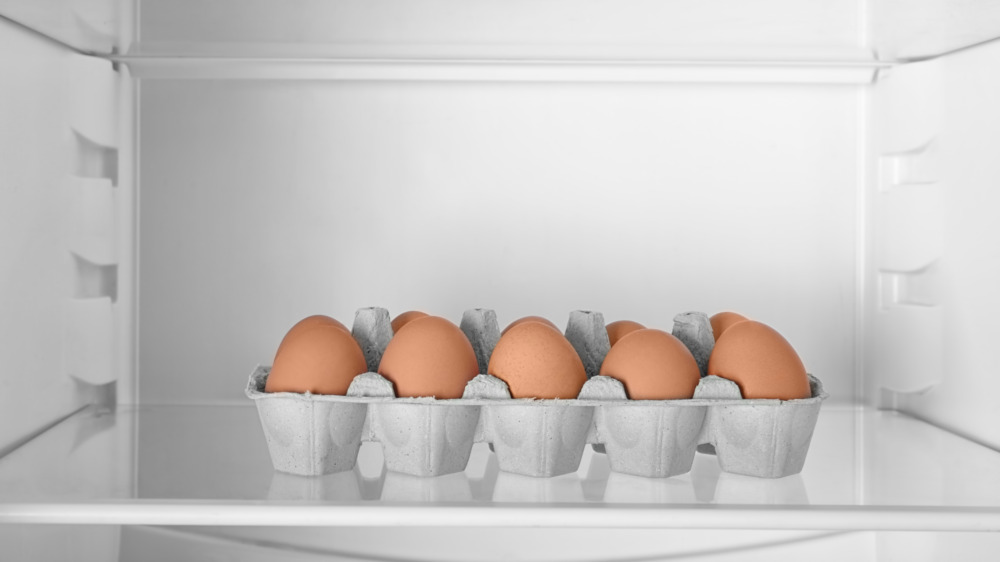 Carton of brown eggs in a refrigerator 