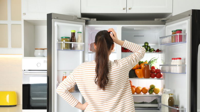 woman looking at fridge