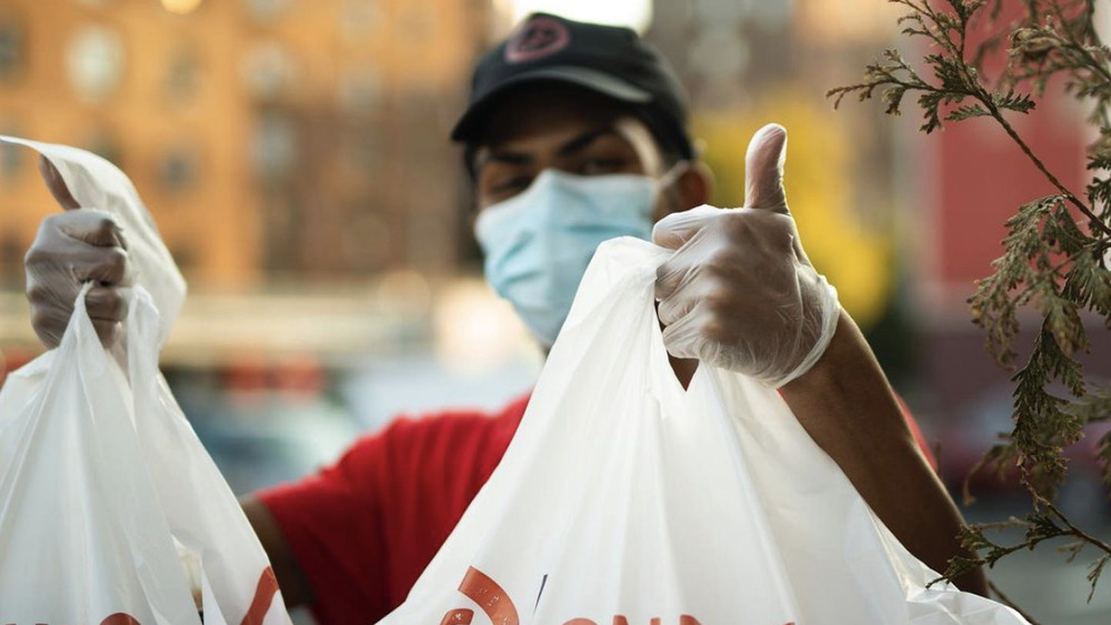 Golden Corral employee with bags of food