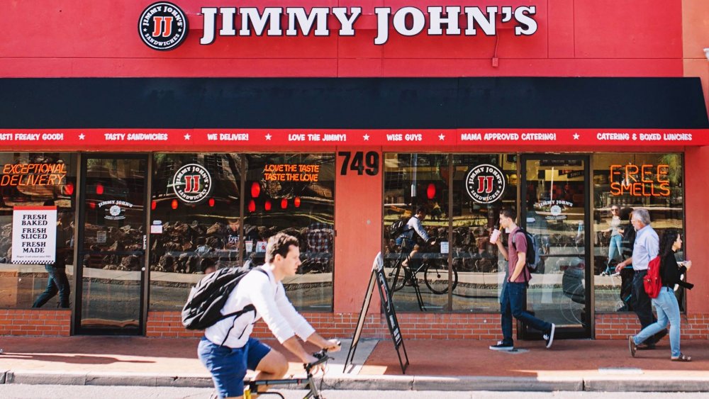 Jimmy John's with bicyclist riding in front of it