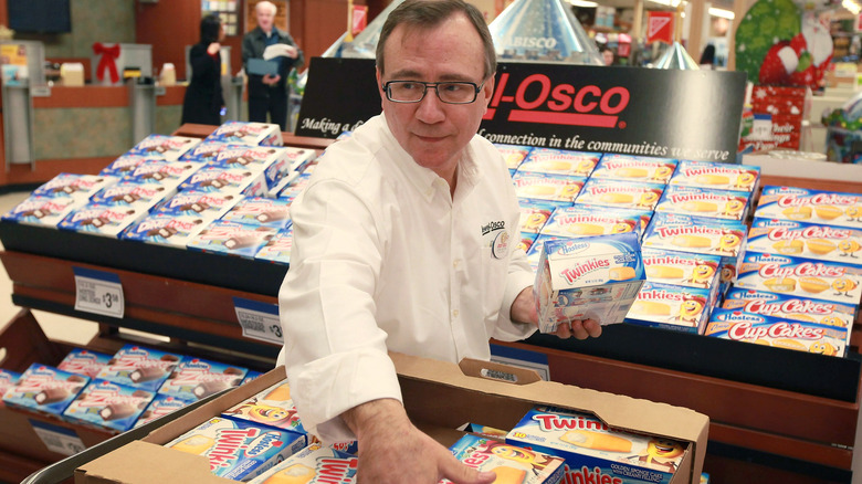 Jewel-Osco worker stacking shelves with candy