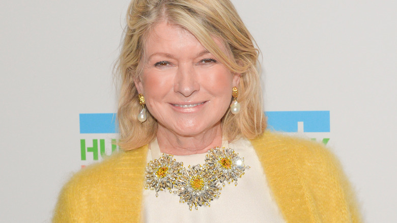 Martha Stewart with wide smile in yellow cardigan