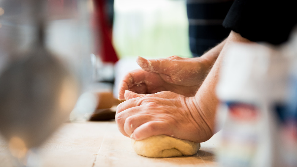 Chef kneading dough