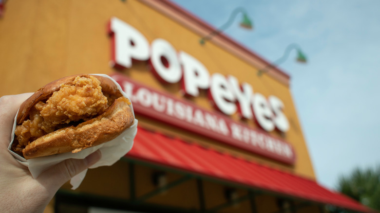 Person holding Popeyes chicken sandwich 