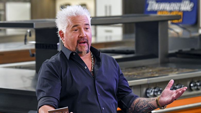 Guy Fieri at a table