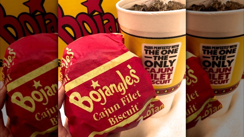 A wrapped Cajun Filet Biscuit and drink from Bojangles.