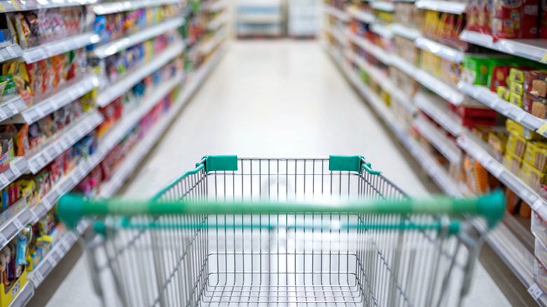 Supermarket carriage going down aisle