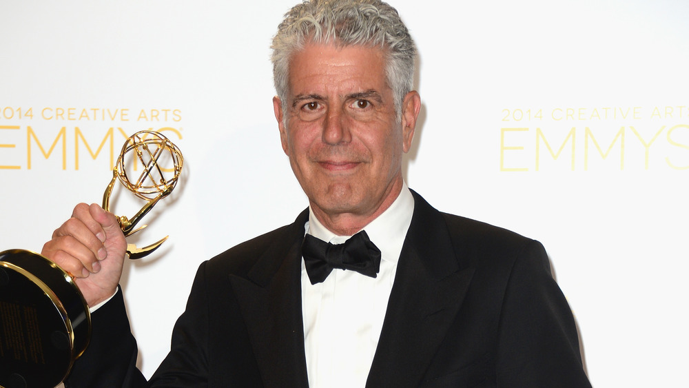 Anthony Bourdain holding Emmy award