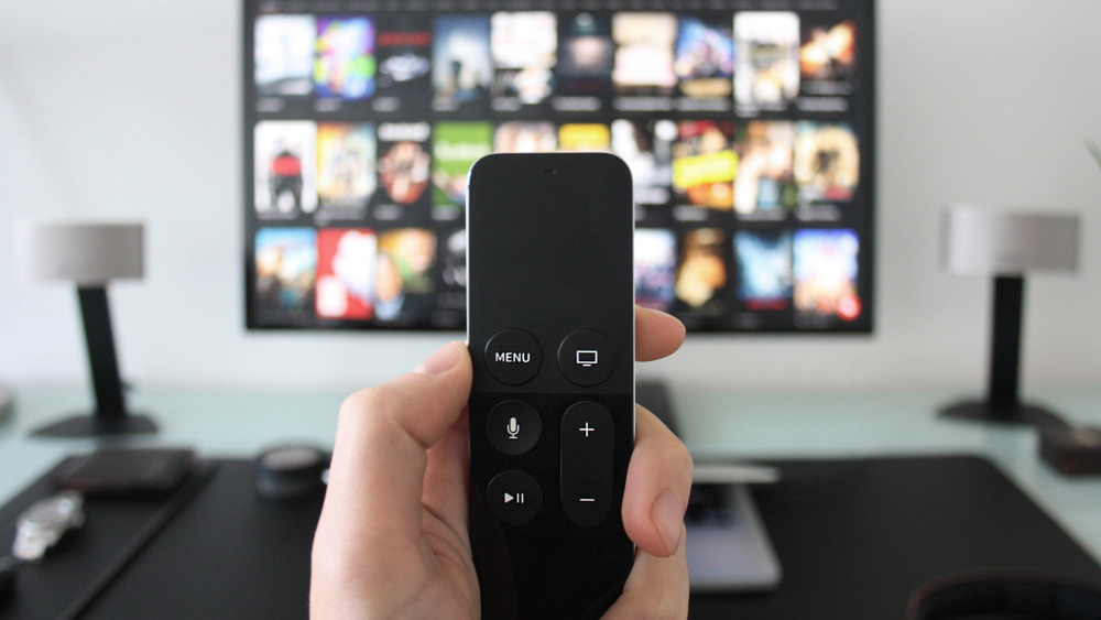 Television and person holding a remote