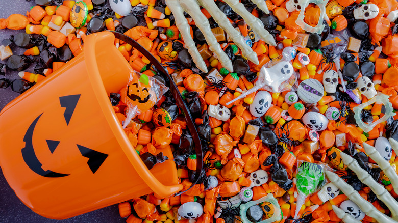 Halloween candy spilling from pumpkin bucket