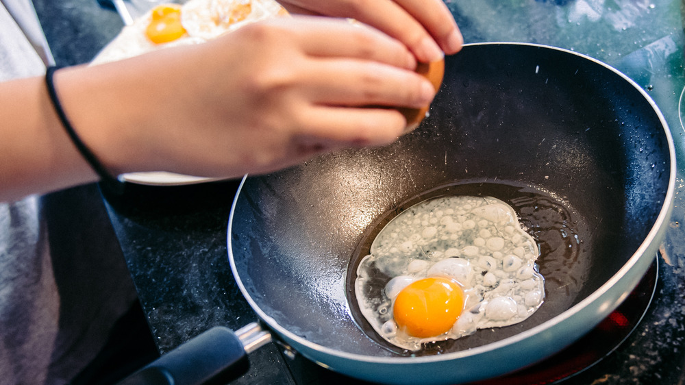 Cracking an egg into a pan