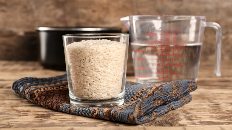 cup of rice and measuring cup of water