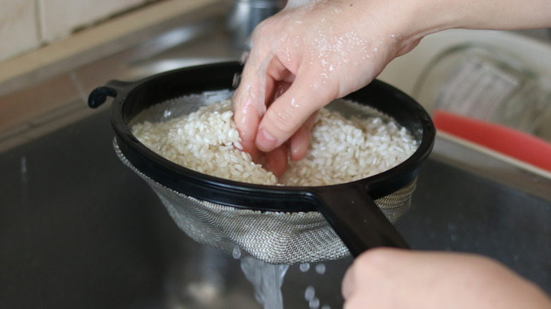 rinsing rice in a strainer